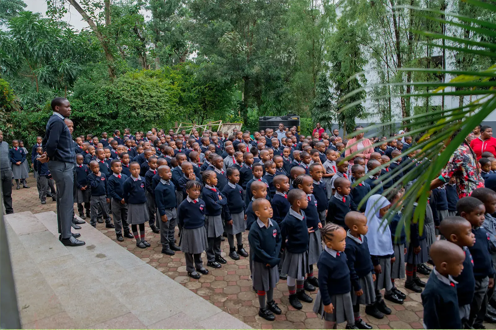 Loamo pupils at morning assembly under the trees